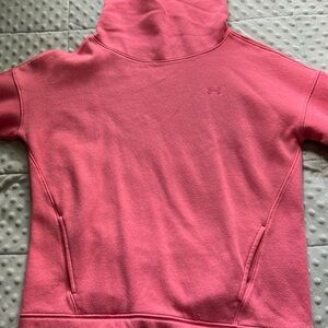 Pink Under Armour turtleneck. With the words Under Armour on the sleeve.
